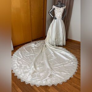 Ivory off the shoulder wedding gown with cathedral length detachable train.